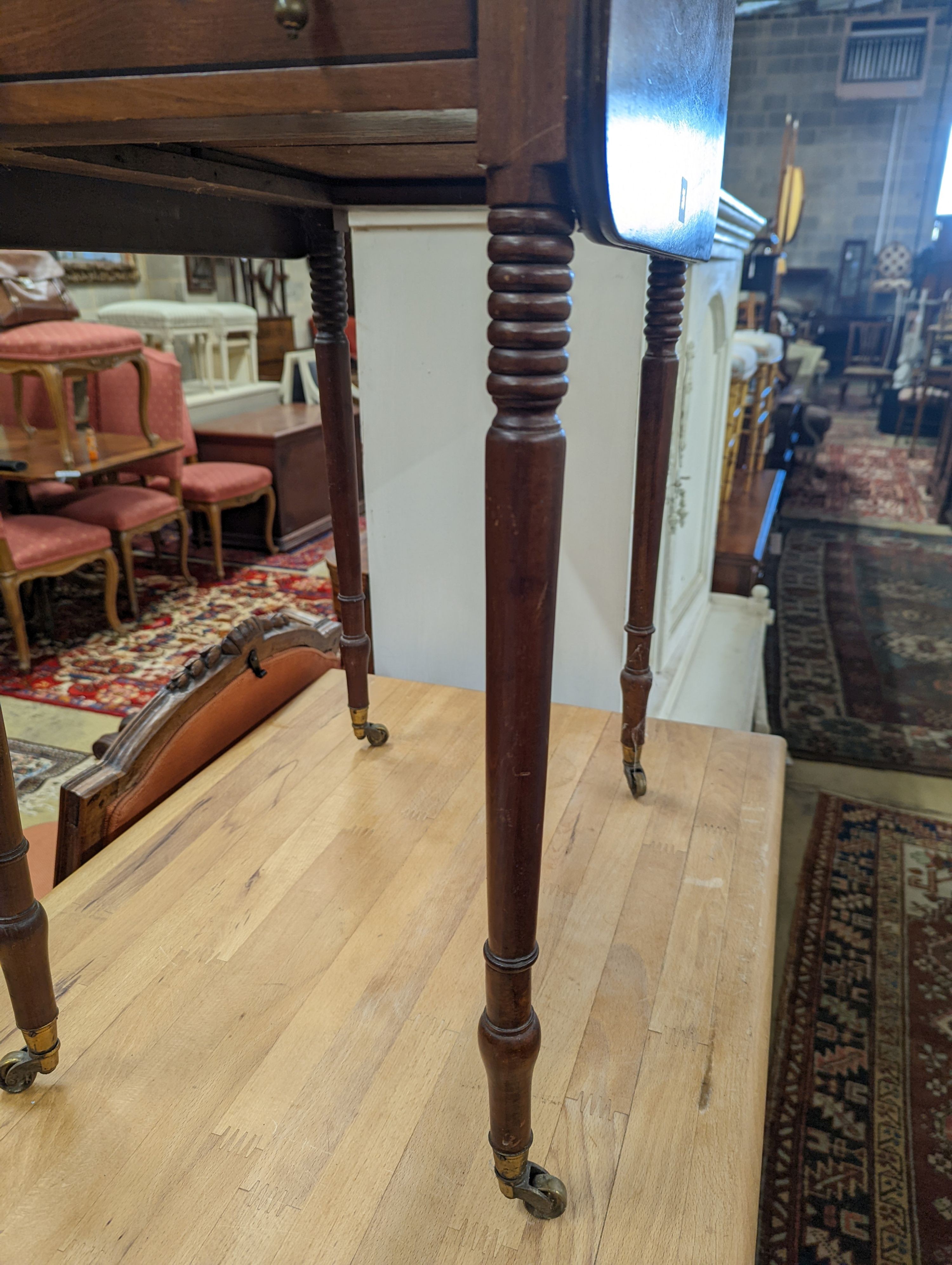 A Regency mahogany drop flap work table, the drawers with brass pear drop handles, width 37cm, depth 53cm, height 73cm